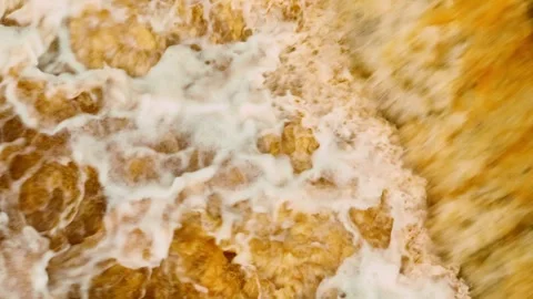 Aerial view captures muddy floodwaters churning turbulently. Stock Footage 310707828