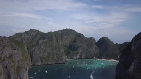 This aerial view captures a serene bay dotted with numerous small boats Stock Footage 319221024