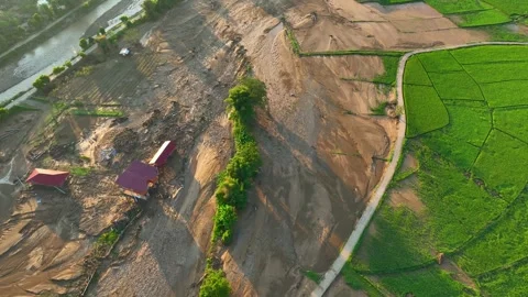 Aerial view captures severe flash flood damage across rice fields. Stock-Footage 347273563