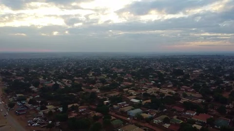 An aerial view captures the sprawling cityscape under a cloudy sky, showcasing Stock Footage 316948863