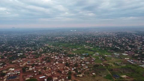 An aerial view captures the sprawling cityscape under a cloudy sky, showcasing Stock Footage 316949099