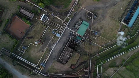 Aerial view captures sprawling geothermal power plant with pipes and buildings. Video stock 336796090