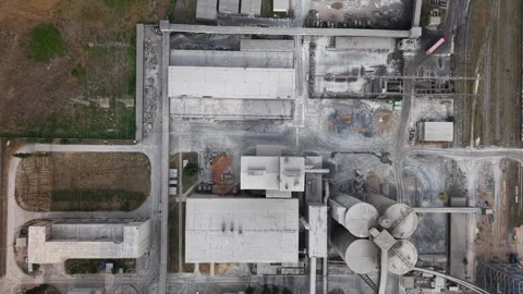 An aerial view captures a sprawling industrial facility with large concrete Stock Footage 342700677