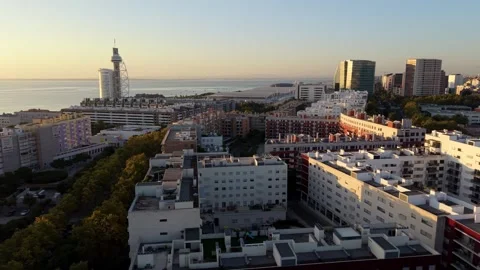 Aerial view captures sunrise over riverside city; Parque das Nacoes Video stock 346071559