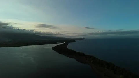 Aerial view captures tranquil coastal waters at twilight. 스톡 동영상 333993496