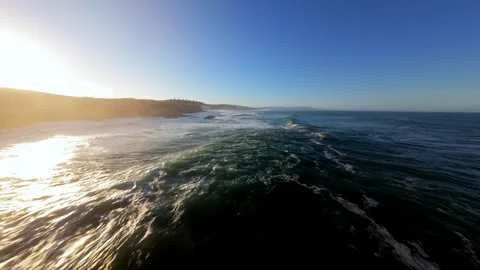 Aerial view captures waves breaking at golden hour; Ericeira Видео 346371288