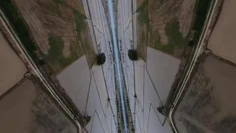 Aerial view captures winding river through rice paddies Stockbeeldmateriaal 345397818