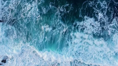 Aerial View Capturing the Dynamic Ocean Waves and Surfing Foam in Irresistible Stock Footage 311582363