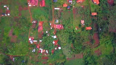 Aerial view capturing the intricate network of small houses, cultivated plots Stock Footage 327612604