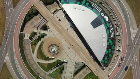 Aerial View Capturing a Modern Circular Structure Encompassing Green Spaces and Stock Footage 302085183