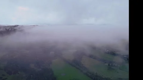 An Aerial View Capturing the Rolling Fog Gently Moving Over a Scenic Landscape Stock Footage 320789717