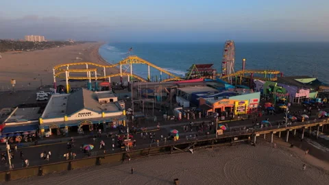An Aerial View Capturing the Stunning Pier and Vibrant Amusement Park at Sunset Video stock 318054306