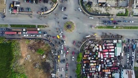 Aerial View Capturing Traffic Flow Around a Roundabout in an Urban Landscape Stock Footage 314403388