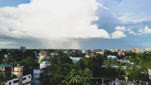 An aerial view capturing a vibrant rainbow arching over the city, as the scene m Stock Footage 287765289