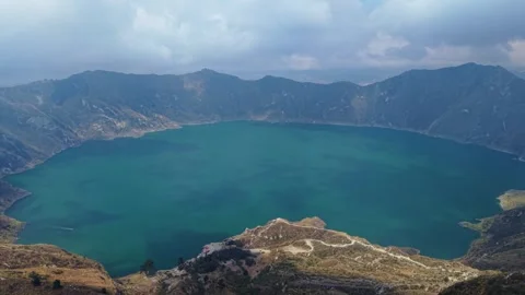 Aerial view capturing vibrant turquoise waters of Quilotoa Lagoon nestled within 스톡 동영상 308403232