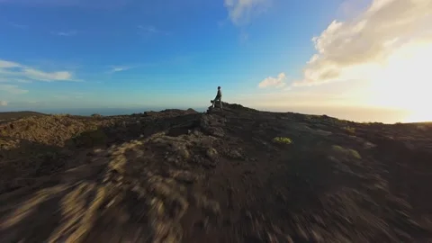 Aerial view capturing volcanic terrain during sunset, revealing hardened lava Stock Footage 308586774