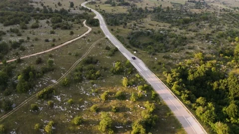 Aerial view of car crossing empty road during sunset, Croatia. Stock Footage 139048142