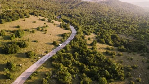 Aerial view of car crossing empty road during sunset, Croatia. Stock Footage 139048193