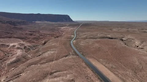 Aerial view of a car driving down a road in northern Arizona Stock Footage 310624314