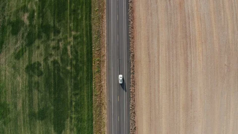 Aerial view of car driving on rural highway Stock Footage