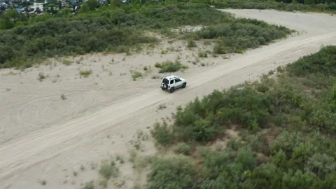 Aerial view of a car driving on sand Stock-Footage 167166350