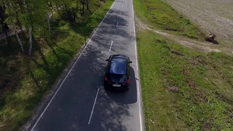 Aerial view of a car driving through scenic road. Stock-Footage 78625913
