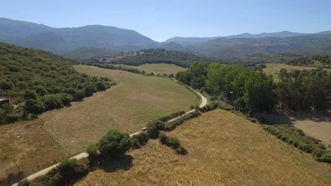 Aerial view of car driving through countryside in Corsica in summer. Stock Footage 85465295