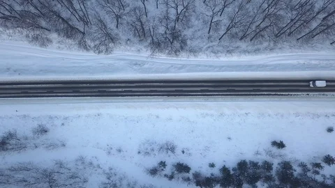 Aerial view on car driving through winter forest road. Scenic winter landscape Video stock 88800738