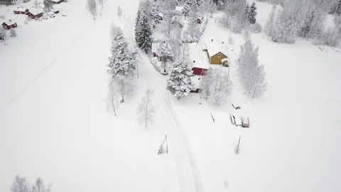 Aerial view of car driving through small countryside village in Finland with Stock Footage 112140245