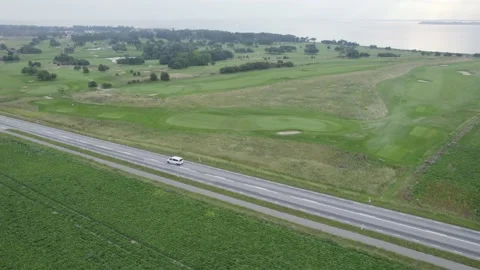 Aerial view of a car driving through a Swedish countryside Stock Footage 163470182
