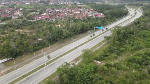 Aerial view of car moving on the road, housing area and plantation Stock Footage 149279947