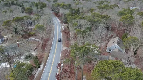 Aerial view of car moving on the road during Winter in Cape Cod, USA Stock Footage 232393034