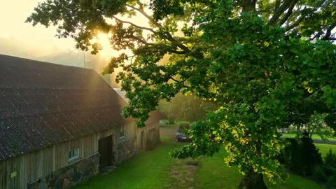 Aerial view of a car parked by a rustic barn in Latvia. Stock Footage 340592938