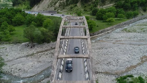 Aerial view. Car passes through the old concrete bridge. 動画素材 90972001