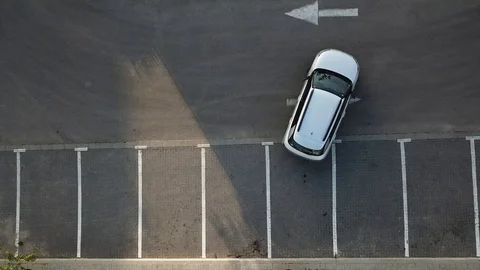 Aerial view of a car pulling out of a parking spot 스톡 동영상 88675662