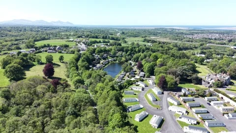 Aerial view of caravan park set within valley greenery and soft natural tones Vídeo Stock 337294388