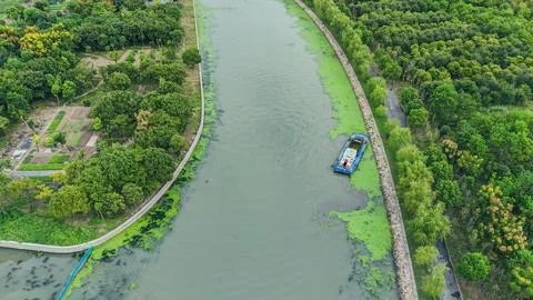 Aerial View of Cargo Barge on Tree-Lined Canal Stock Photos