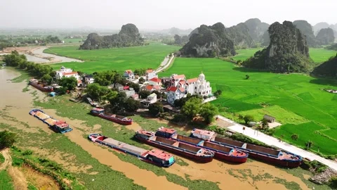 Aerial view of cargo barges floating on the river a rural village in ninh b.. Video stock 335088399