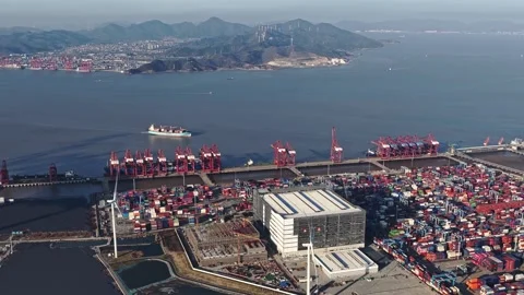 Aerial view cargo containers port. Industrial wind turbines Renewable eco energy 库存影片 334126455