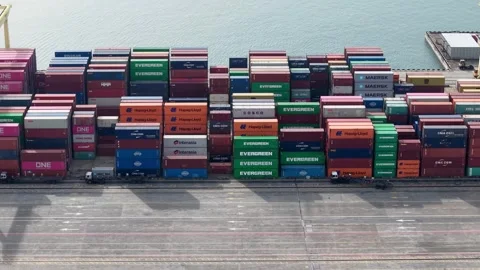 Aerial view of cargo containers stacked high on a dock Stock Footage 338994873
