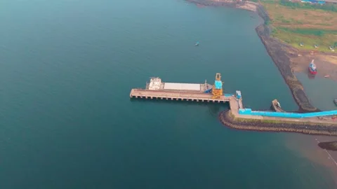 Aerial view cargo craft docked near stony coast pier Video stock 314178286