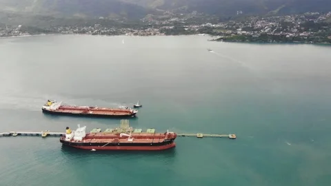 Aerial View Of A Cargo Ship And A Barge On A Roadstead Away From The Shore Stock Footage 191582074