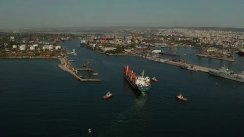 Aerial view of cargo ship calling into the port for repair under the guide of tu 스톡 동영상 154464714