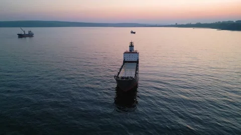 Aerial view of cargo ship on calm sea at sunset Stock-Footage 331801148