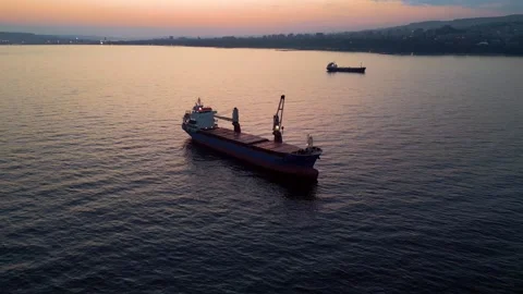 Aerial view of cargo ship on calm sea at sunset 스톡 동영상 331802158