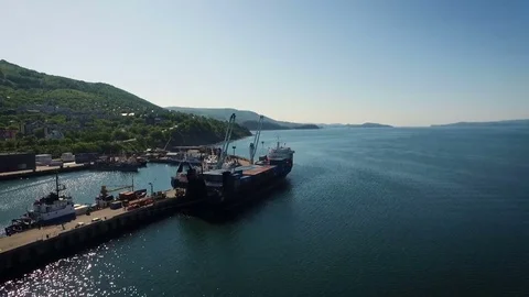 Aerial view of cargo ship with containers at the pier on the background of the Stock-Footage 84743875