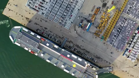 Aerial view cargo ship docking in port warehouse full of cars import container Stock Footage 336446134