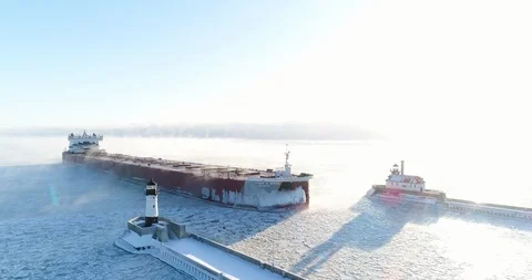 Aerial View of Cargo Ship Entering Duluth's Port in Winter Stock Footage 99966376