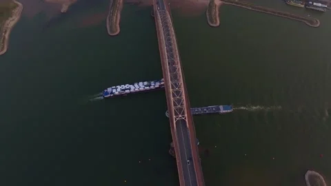 Aerial view of cargo ship loaded with new cars on river at sunset Stock Footage 306492226