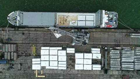Aerial view of cargo ship loading blocks at a port, Latvia. 스톡 동영상 340813358
